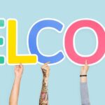 Several hands hold up the word WELCOME to welcome new patients to Jonesboro Dental Care
