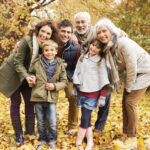 Family in a park during fall all smiling together in jonesboro