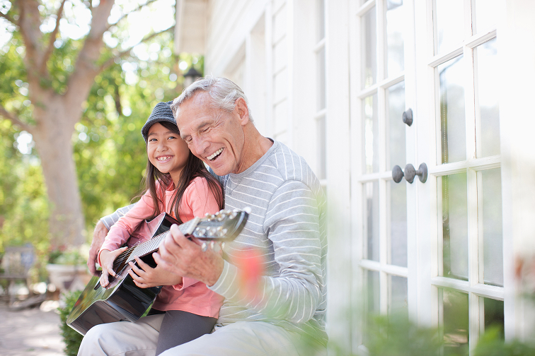 grandad and granddaughter playing guitar