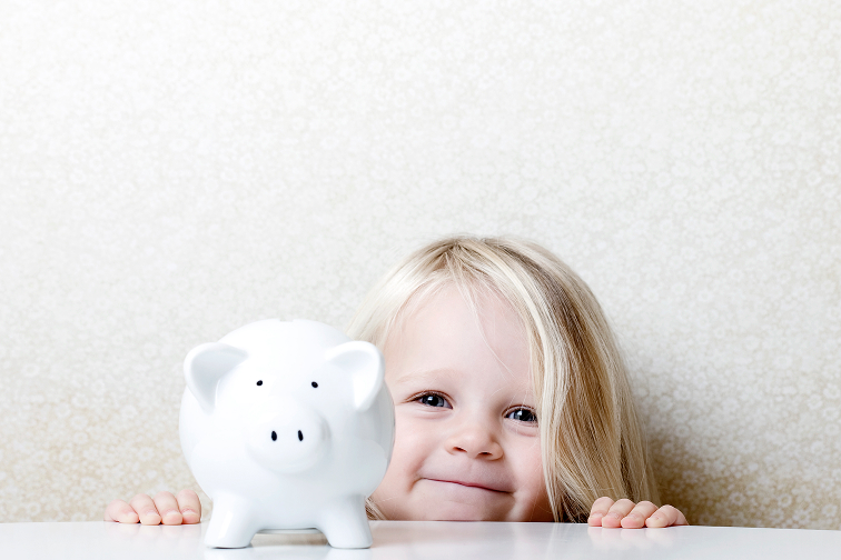 little girl with piggy bank