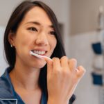 habits for a healthier smile, healthy smile, woman brushing her teeth